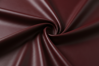 close up of high quality butterly soft textured vegan leather for apparel bold burgundy color,